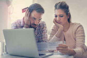 Couple stressed looking at a bill