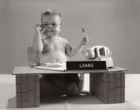 Baby At Desk Playing Loan Officer.