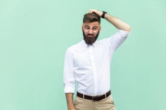 Man confused scratching head