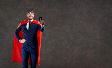 A funny man in a superhero costume keeps a credit card