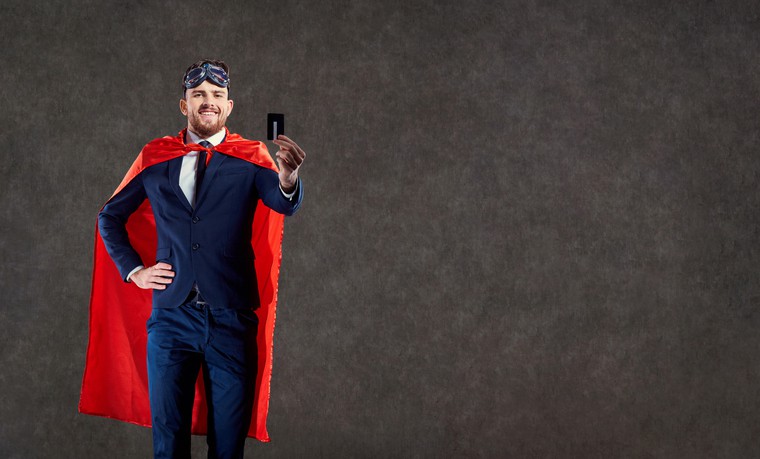 A funny man in a superhero costume keeps a credit card