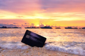 Credit card on the tropical beach.