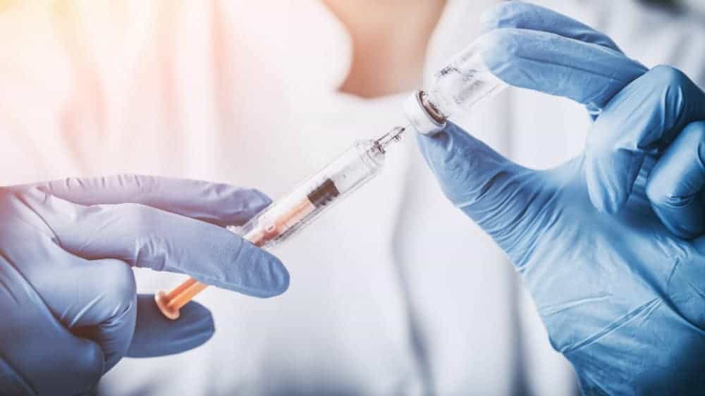 Scientist filling a needle