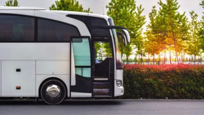 travel company bus greets tourists at the airport to take to the hotel