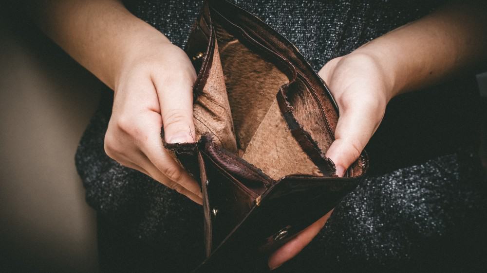 Old empty wallet in hands.
