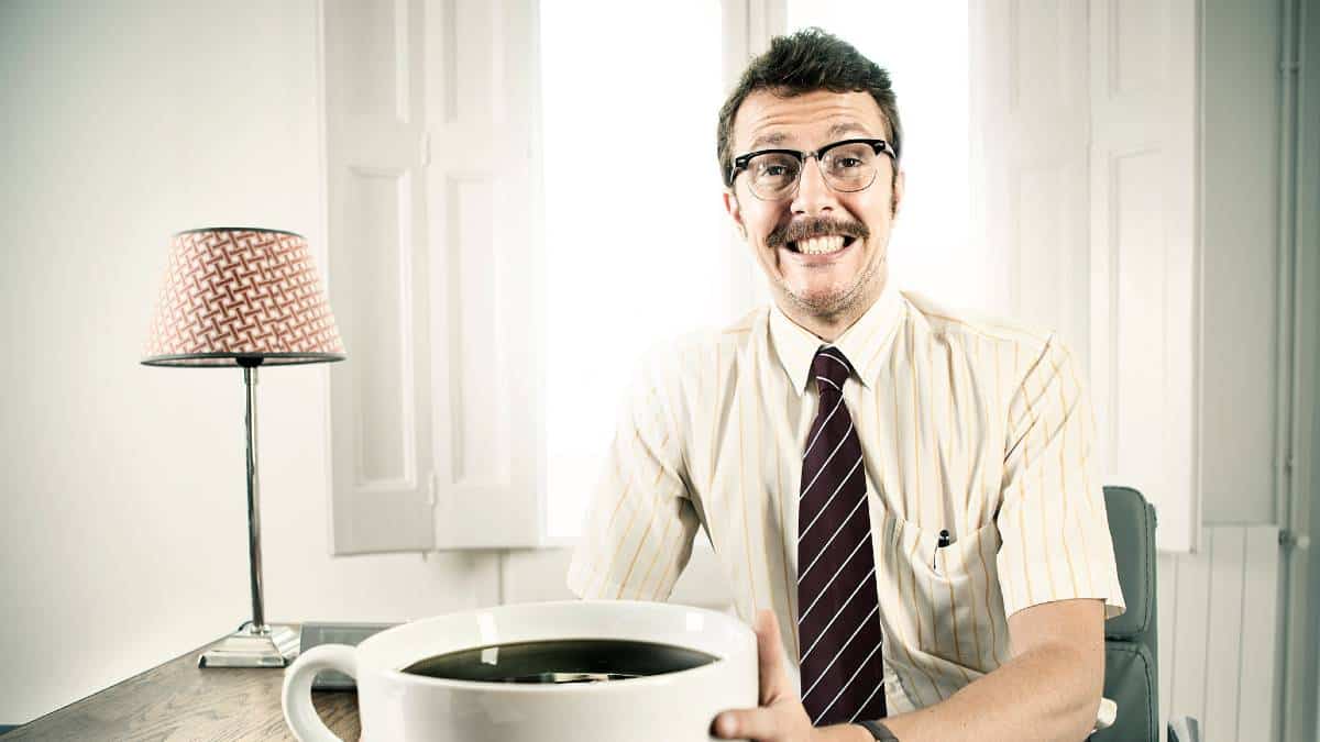 Businessman with oversized coffee cup