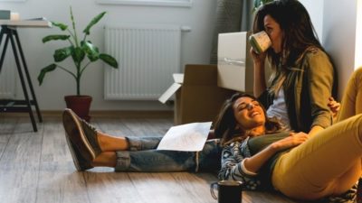 Female couple moving into apartment