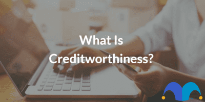 Woman working on laptop with the text “What is creditworthiness?” and The Motley Fool jester cap logo