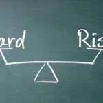 Chalkboard representation of risk versus reward on a pair of scales