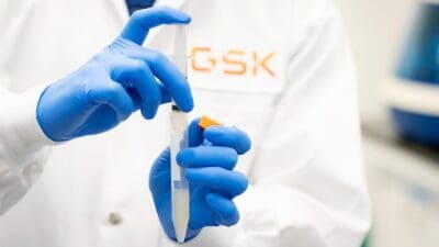 GSK scientist holding lab syringe