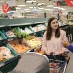 Tesco employee helping female customer