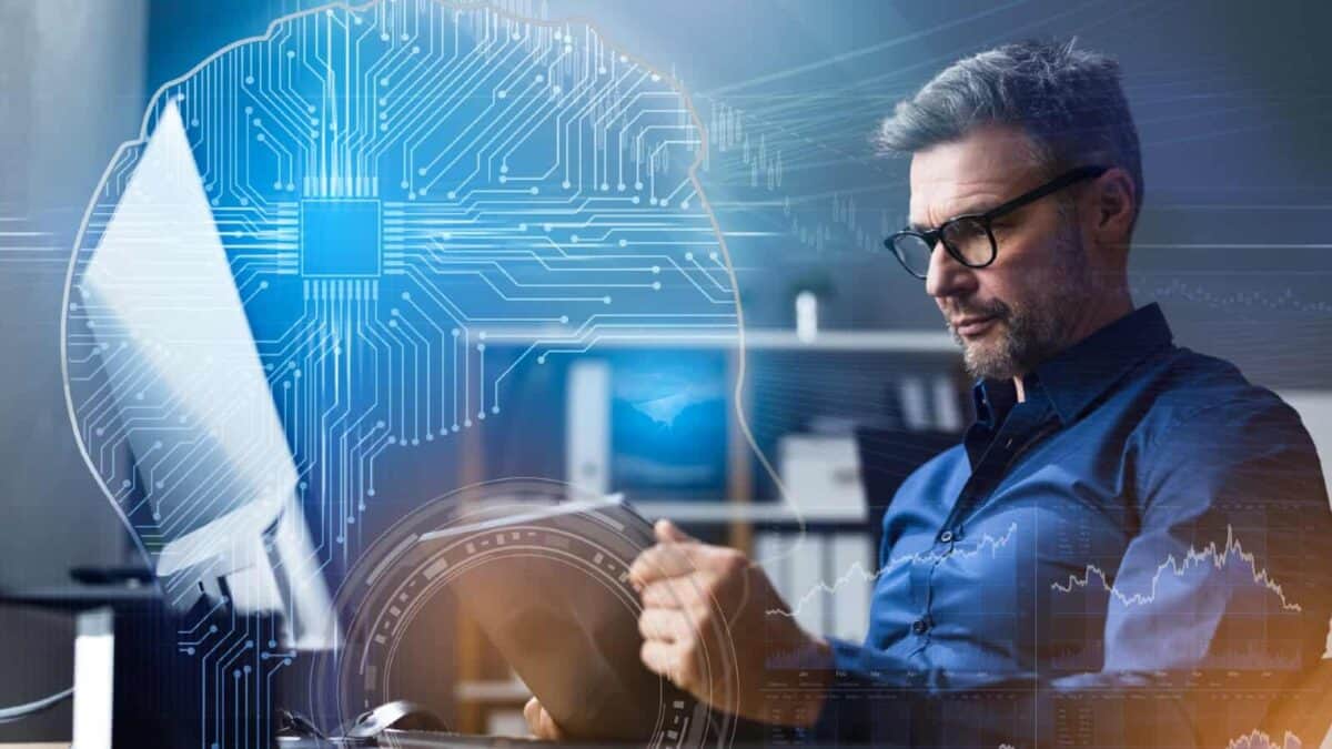 Man reading a tablet, with a wired brain and stock charts in mind