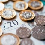 British coins and bank notes scattered on a surface