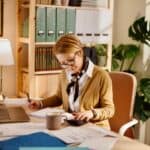 Middle aged businesswoman using laptop while working from home