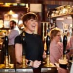 Landlady greets regular at real ale pub
