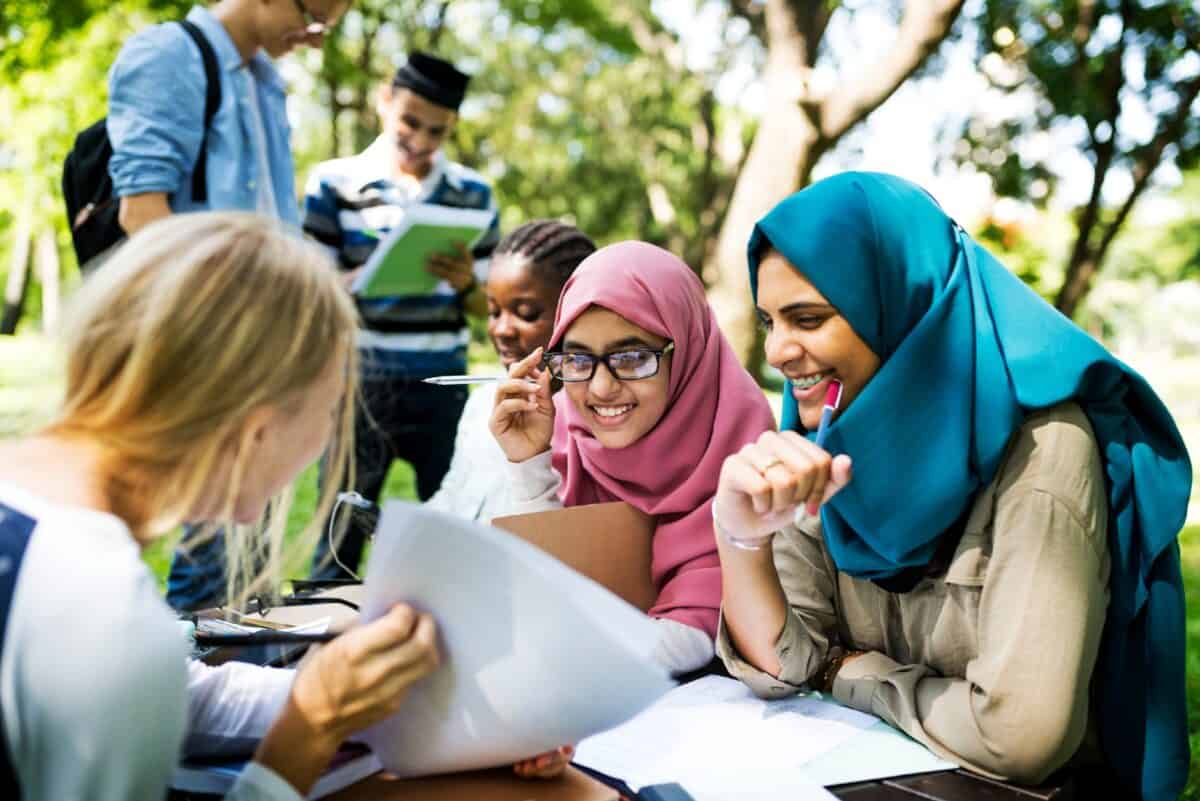 Diverse children studying outdoors