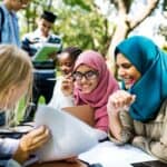 Diverse children studying outdoors
