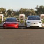 4 Teslas in a parking lot at a charger station