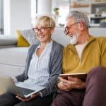 Happy senior couple hugging and enjoying retirement at home